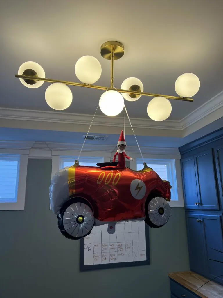 elf on the shelf riding a car balloon