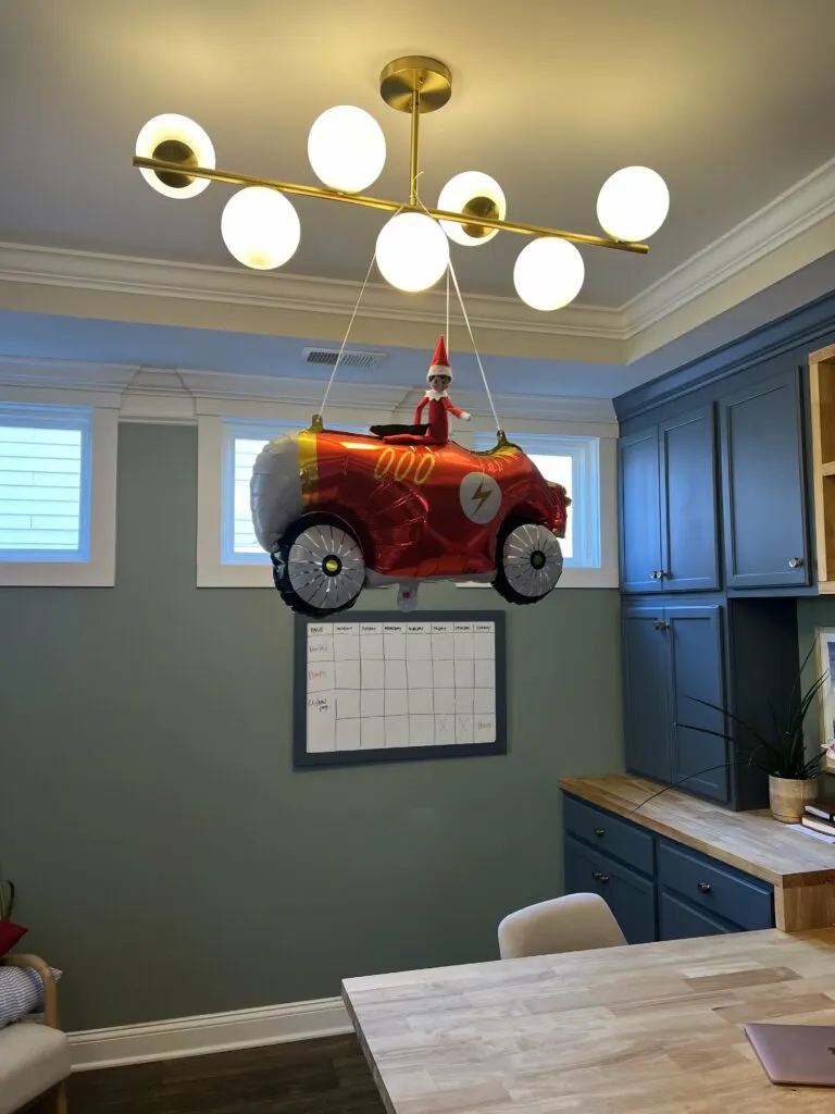 elf on the shelf riding a car balloon