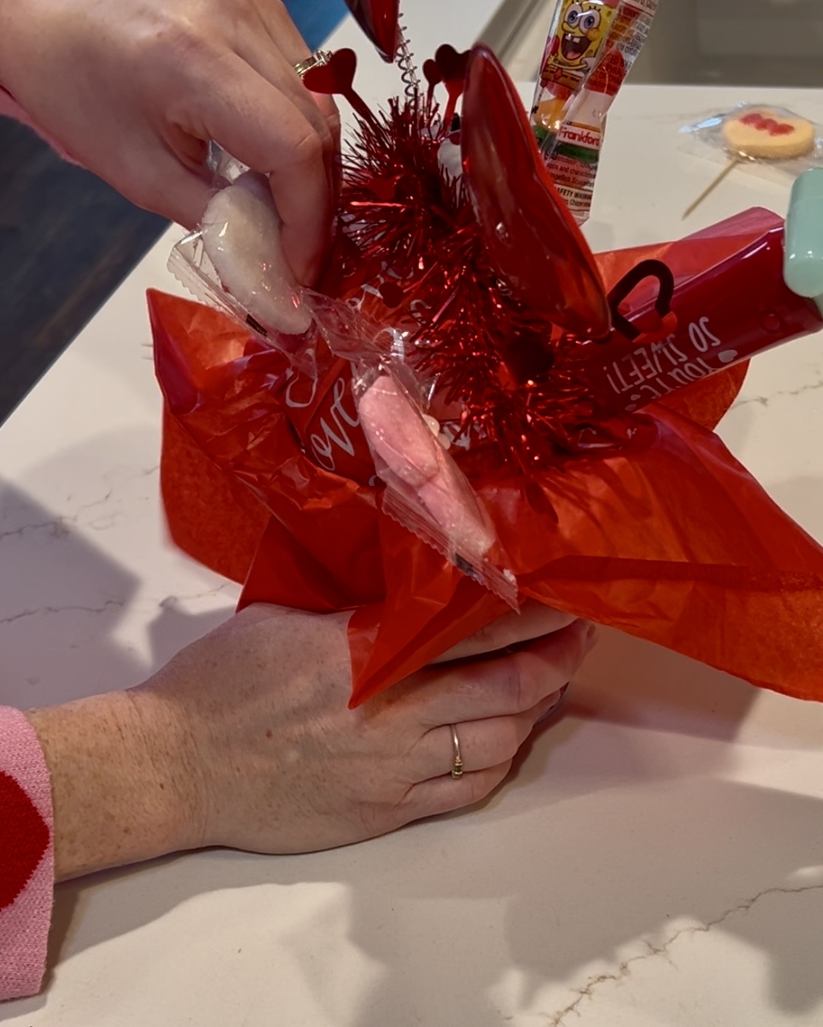 adding candy picks to a valentines day candy bouquet