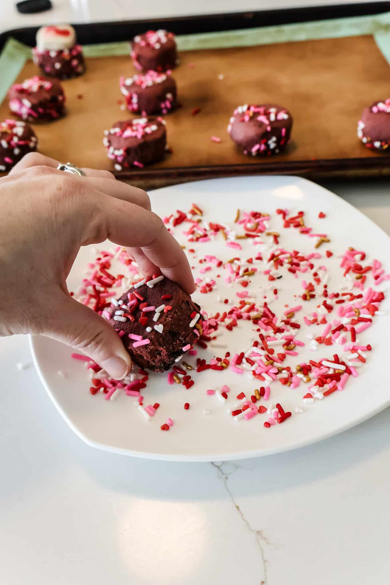 rolling cookie dough in sprinkles