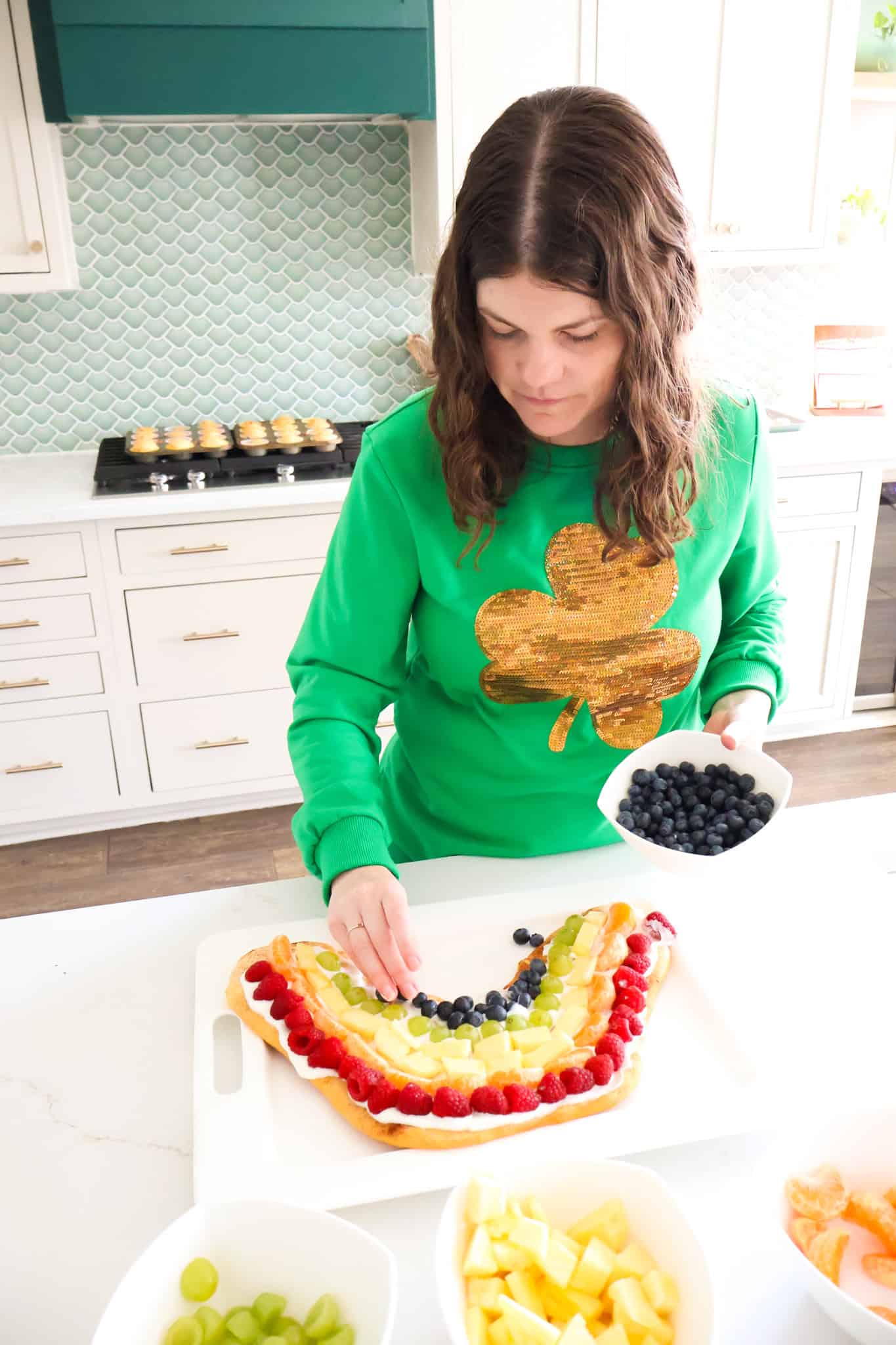 adding fruit to fruit pizza