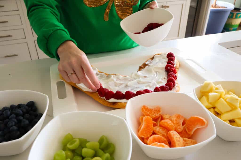 adding fruit to fruit pizza