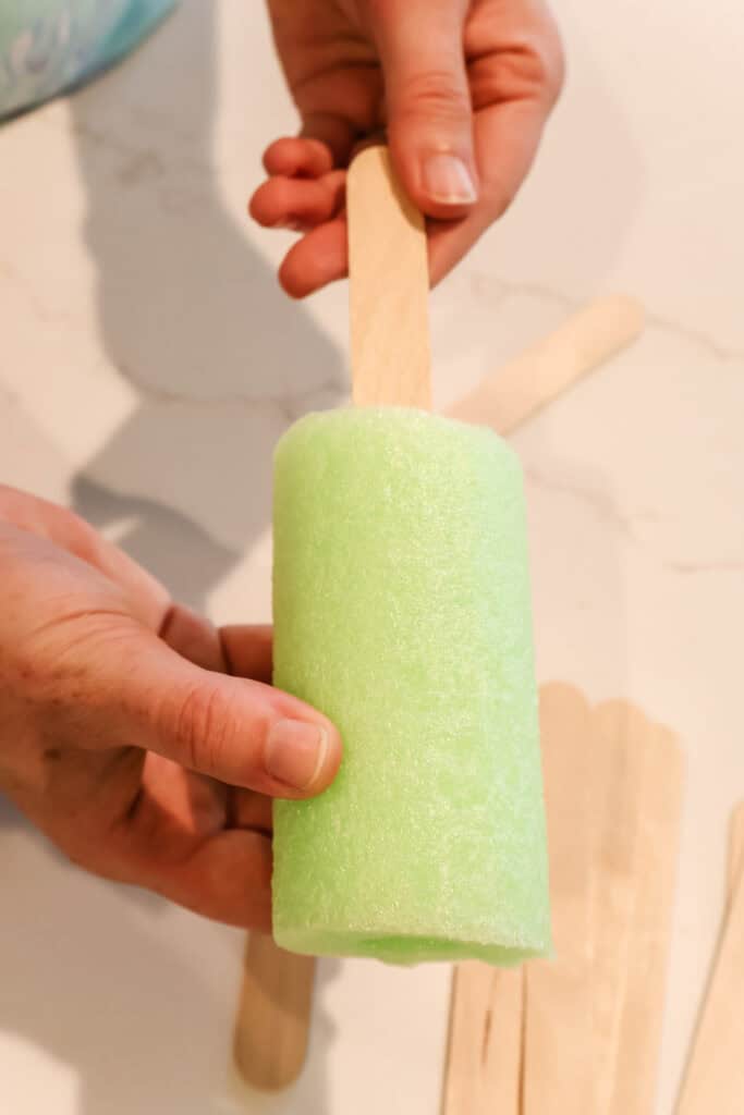 hot gluing popsicle sticks to make popsicles
