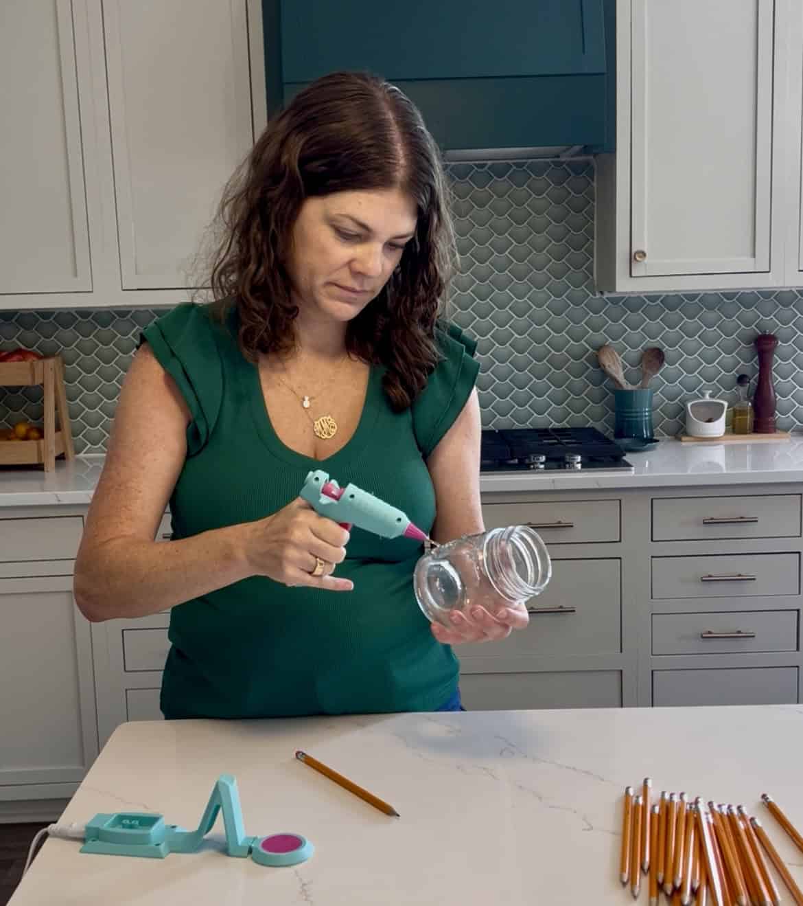 hot gluing pencils to a jar