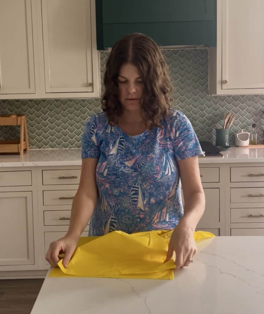 stacking yellow plastic tablecloths