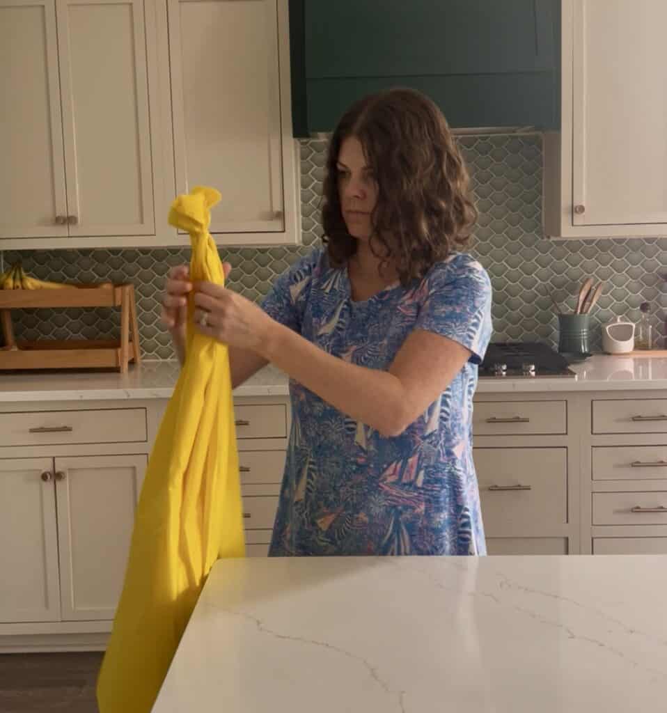 stacking yellow plastic tablecloths