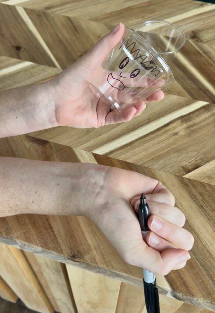 drawing halloween faces on clear plastic cups