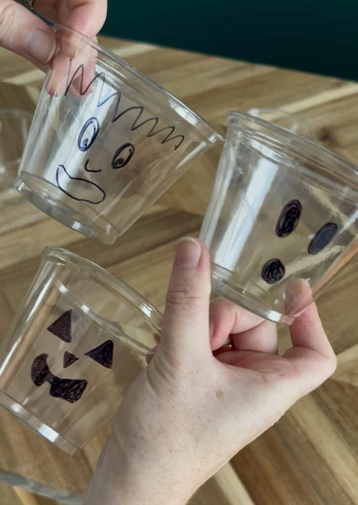 drawing halloween faces on clear plastic cups