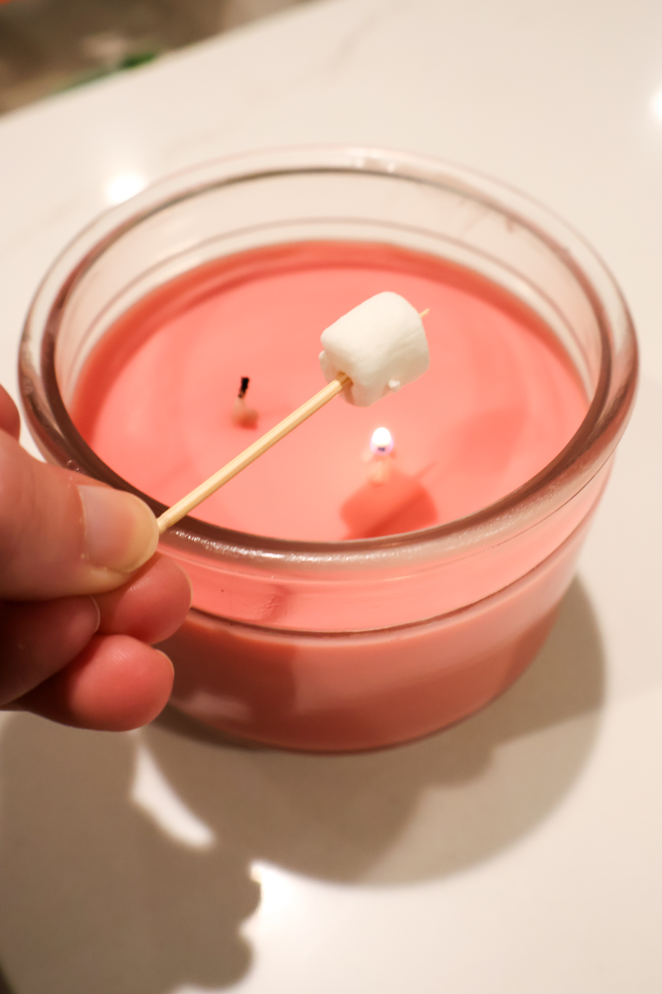 roasting mini marshmallows on a candle
