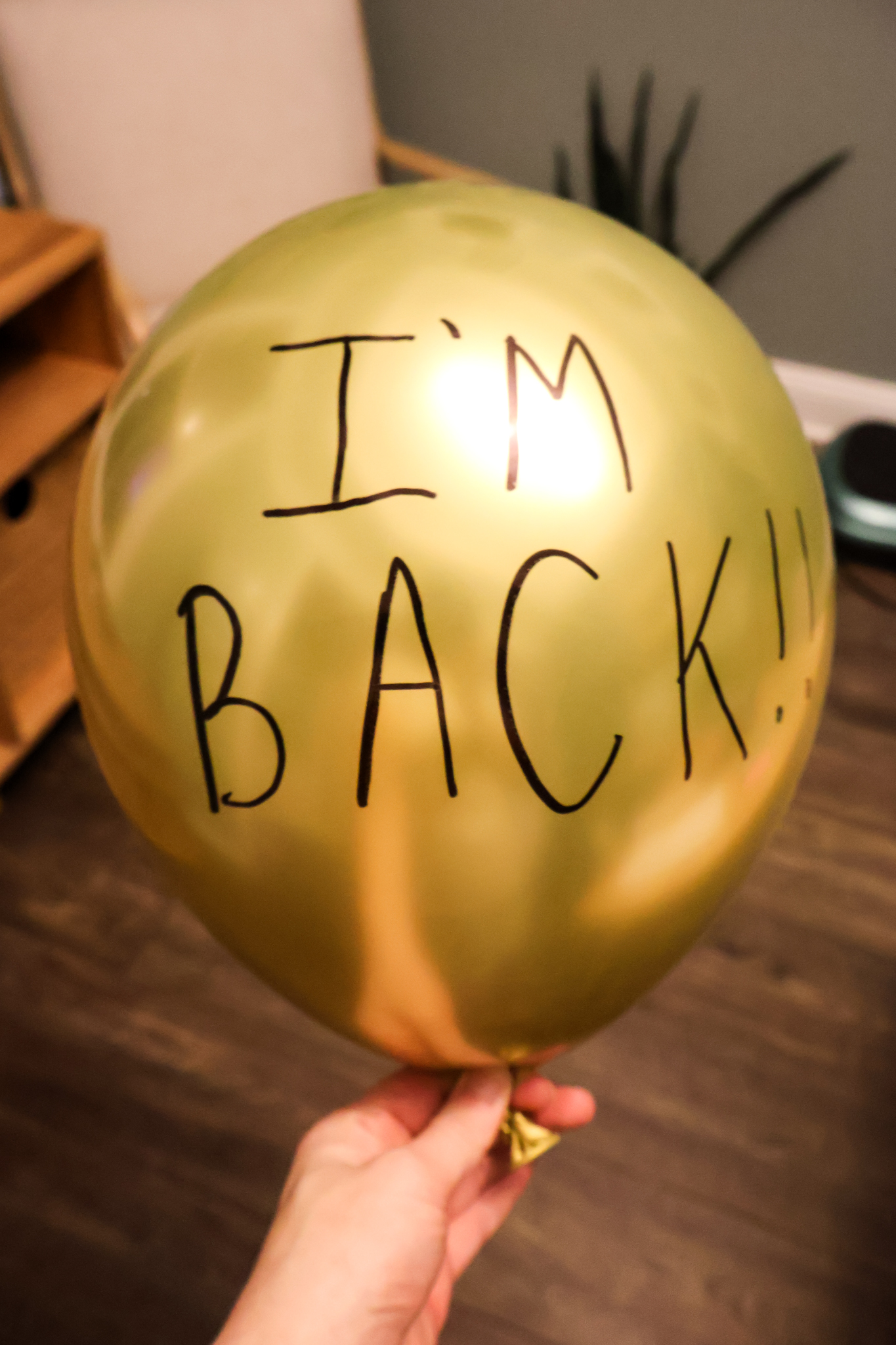 gold balloon with writing on it