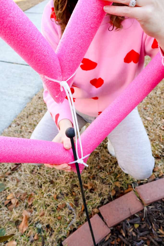 mounting pool noodle hearts in the yard