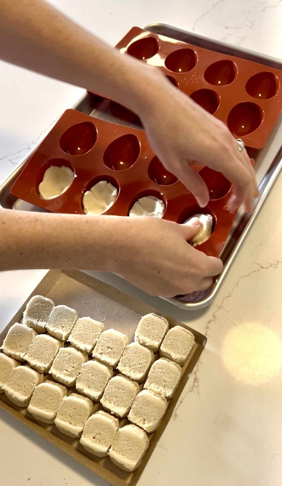 pressing cookie dough into an egg mold