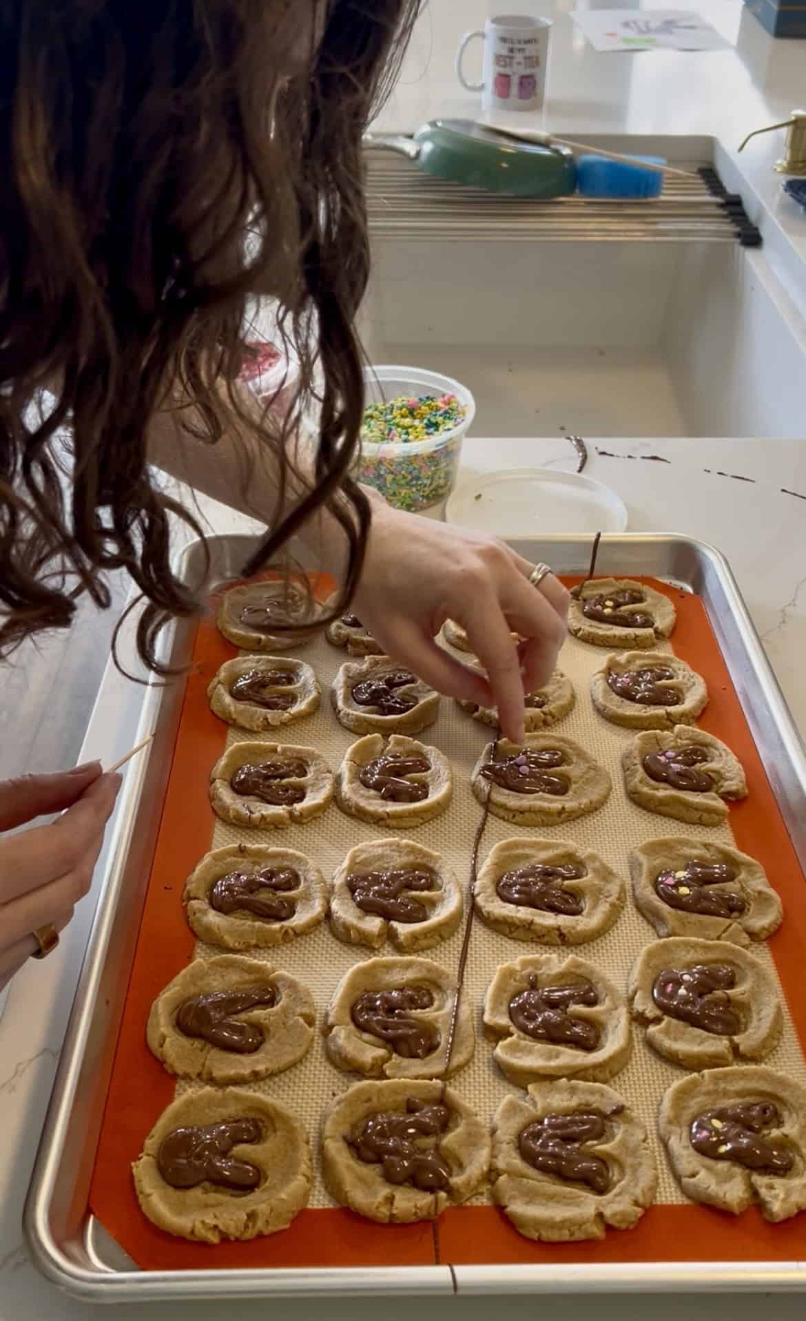 adding sprinkles to bunny cookies