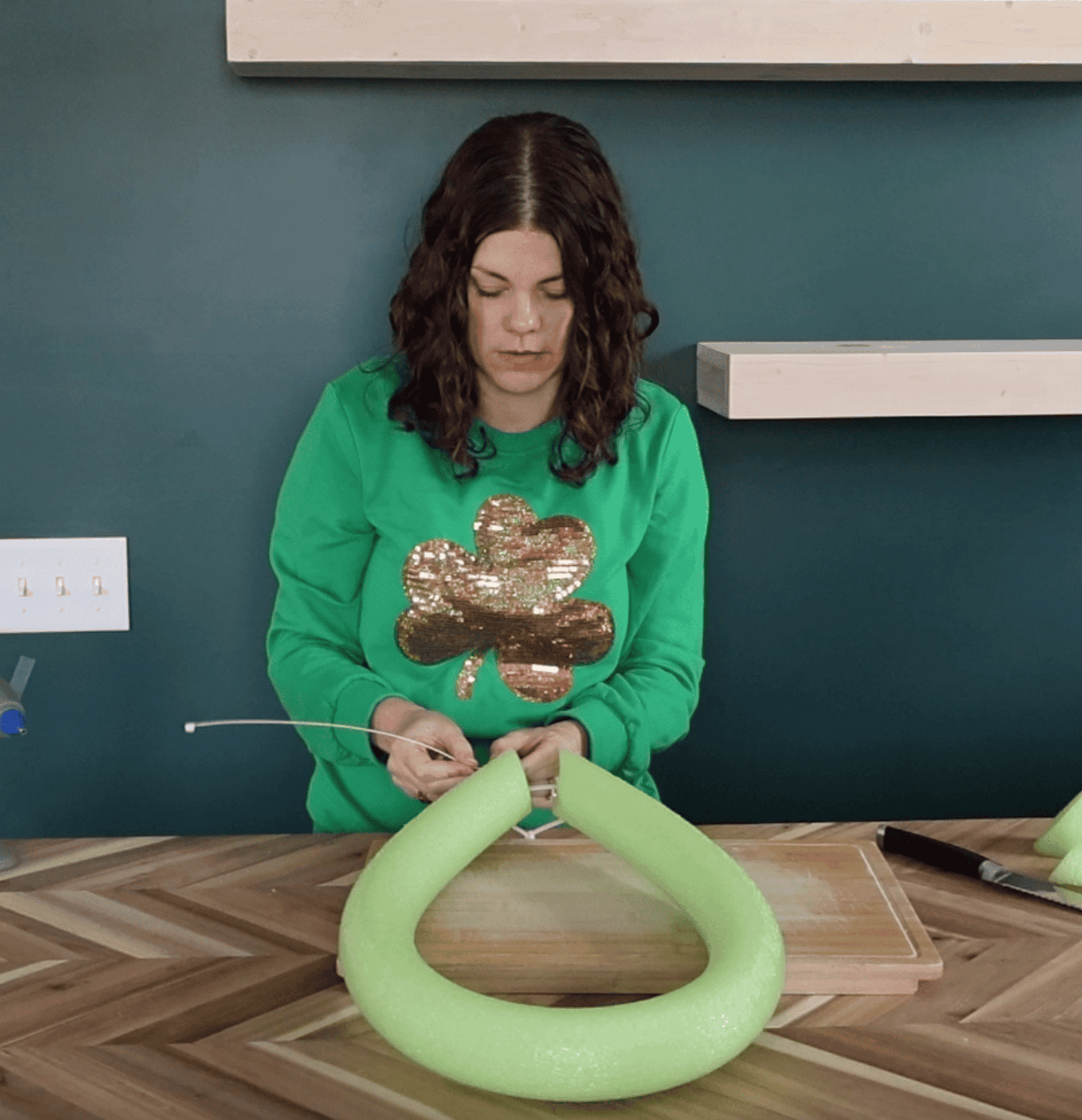 zip tying pool noodles to create leaves