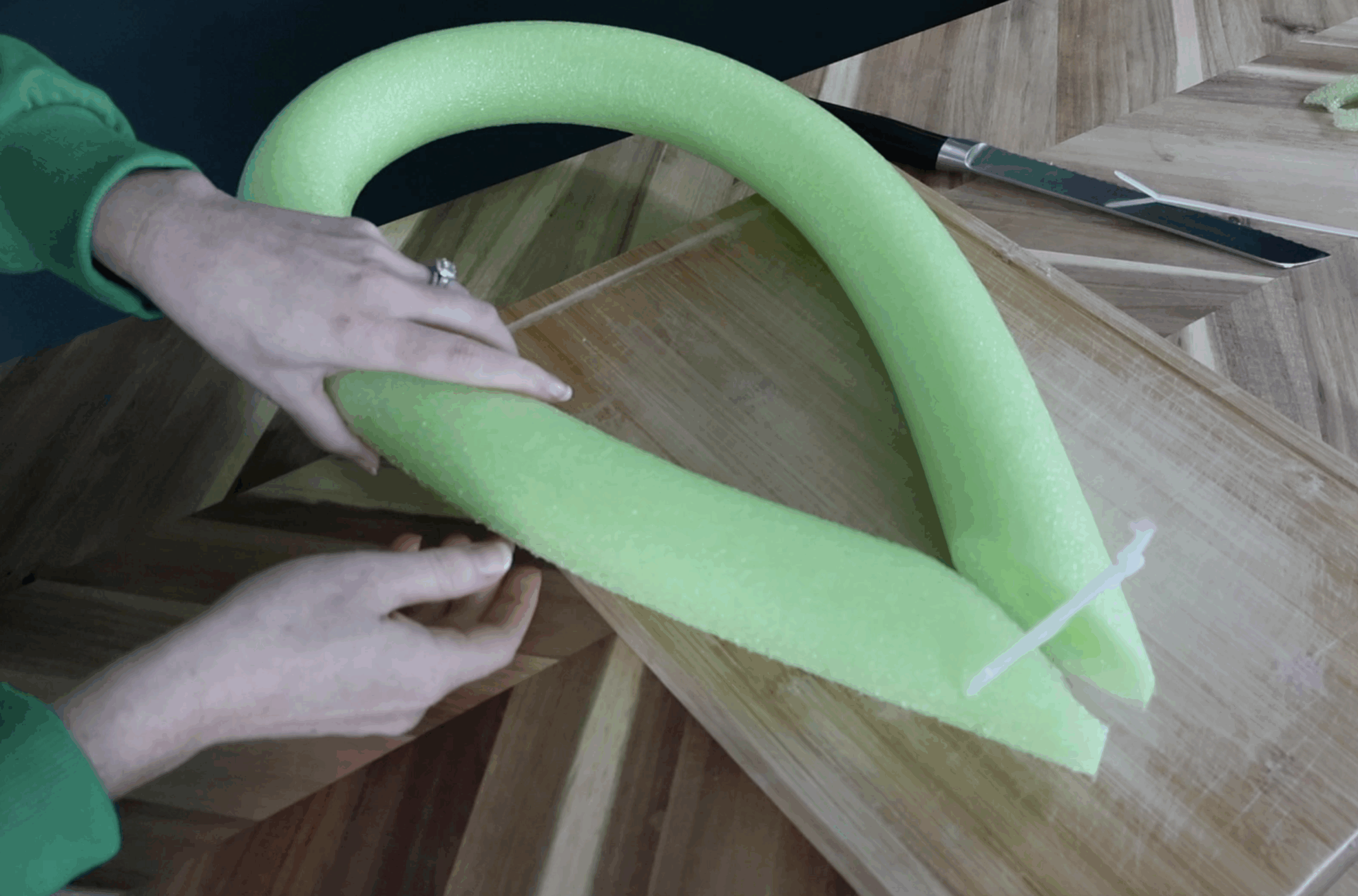 zip tying pool noodles to create leaves