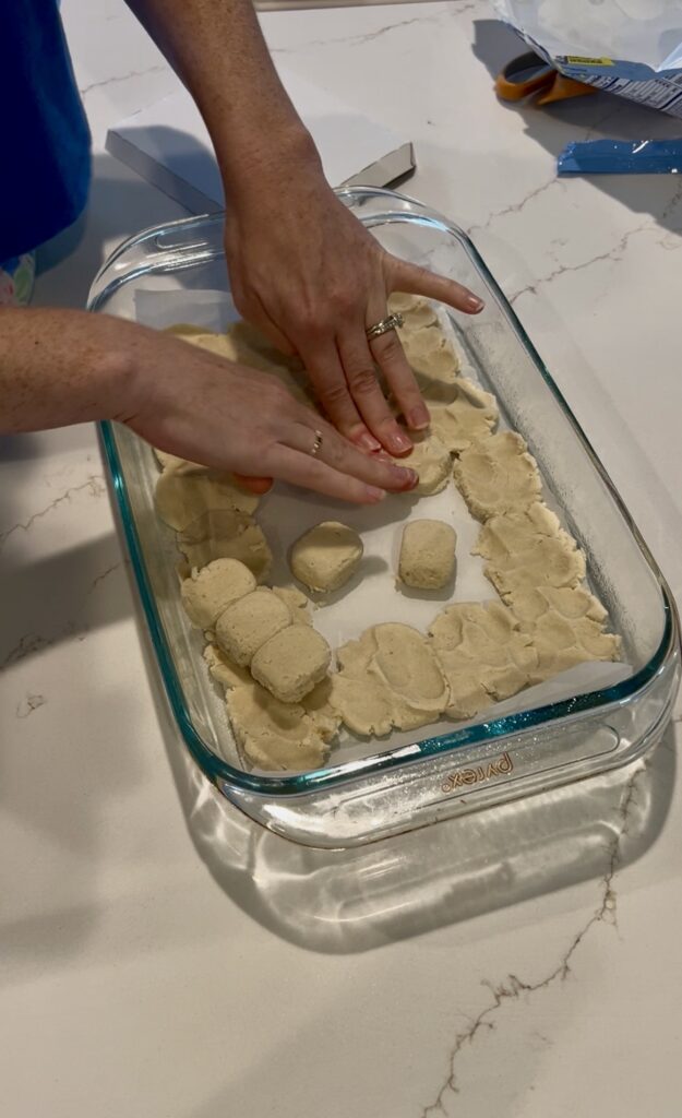 pressing sugar cookie dough into a pan