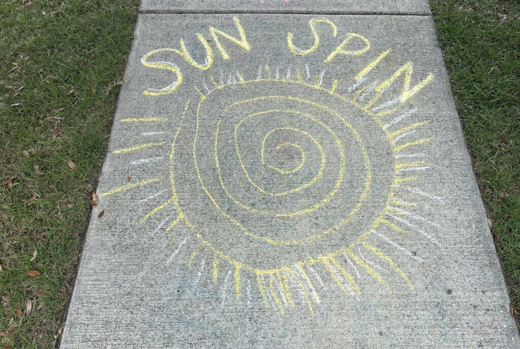 summer sidewalk chalk obstacle course - sun spin