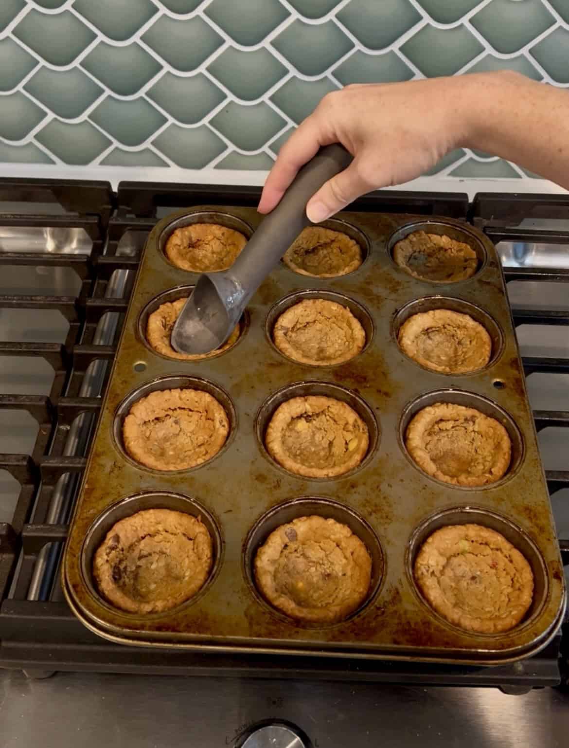 pressing cookies into muffin tin