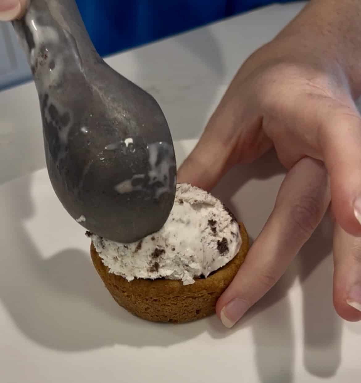 adding ice cream to a cookie