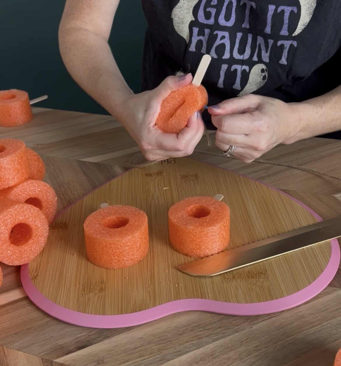 stringing up pool noodle pumpkins