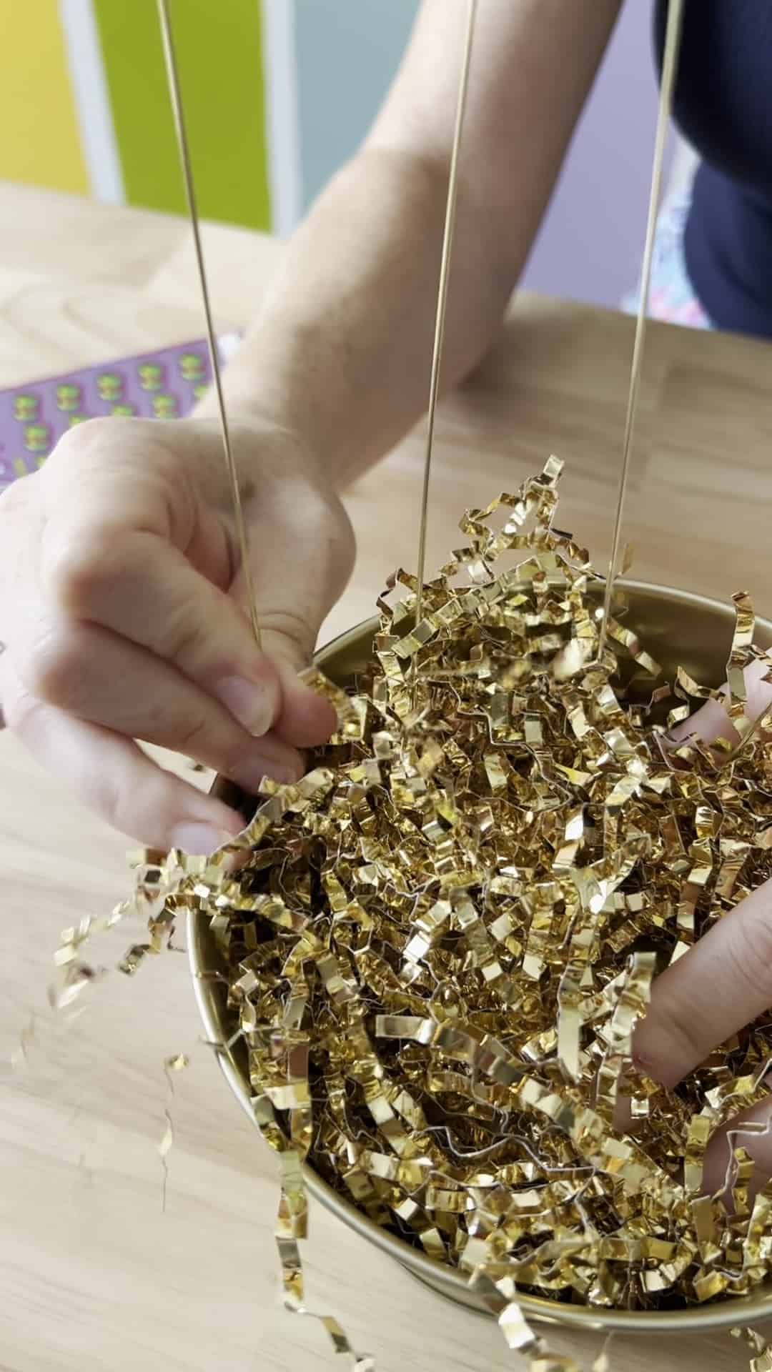 adding floral picks to a gift basket